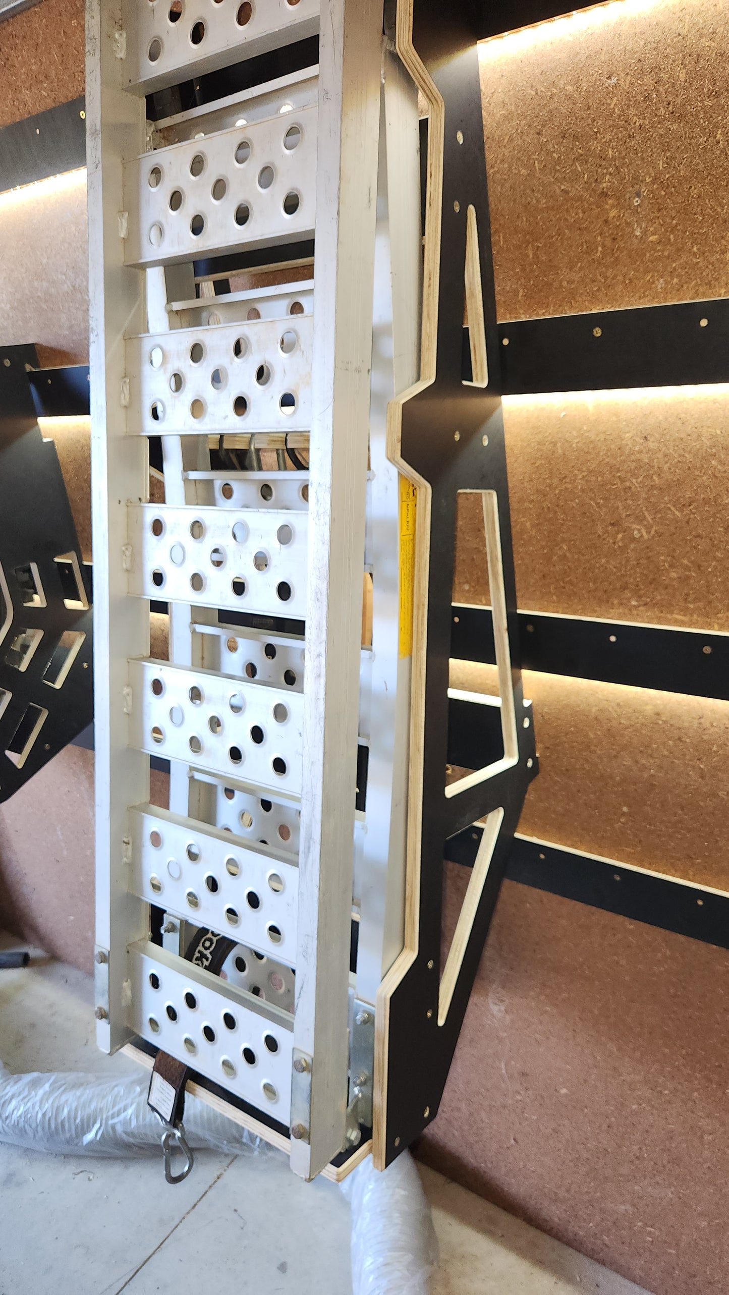 MX - loading ramp storage + tie down storage.